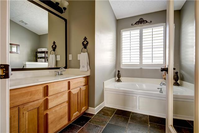 4011 Timber Ridge Court Mount Juliet, TN 37122 - Photo 11 of 20 a bathroom with a tub sink and mirror