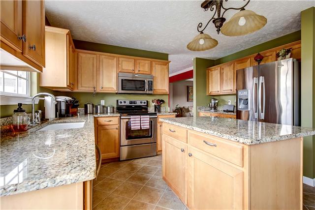 4011 Timber Ridge Court Mount Juliet, TN 37122 - Photo 6 of 20 a kitchen with stainless steel appliances granite countertop a sink a stove and cabinets