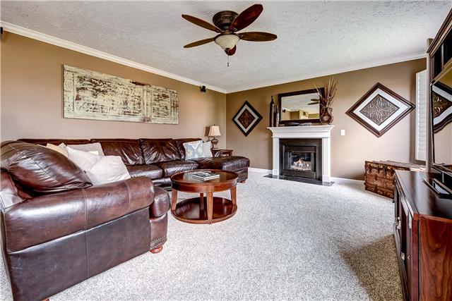 4011 Timber Ridge Court Mount Juliet, TN 37122 - Photo 7 of 20 a living room with furniture a fireplace and a flat screen tv