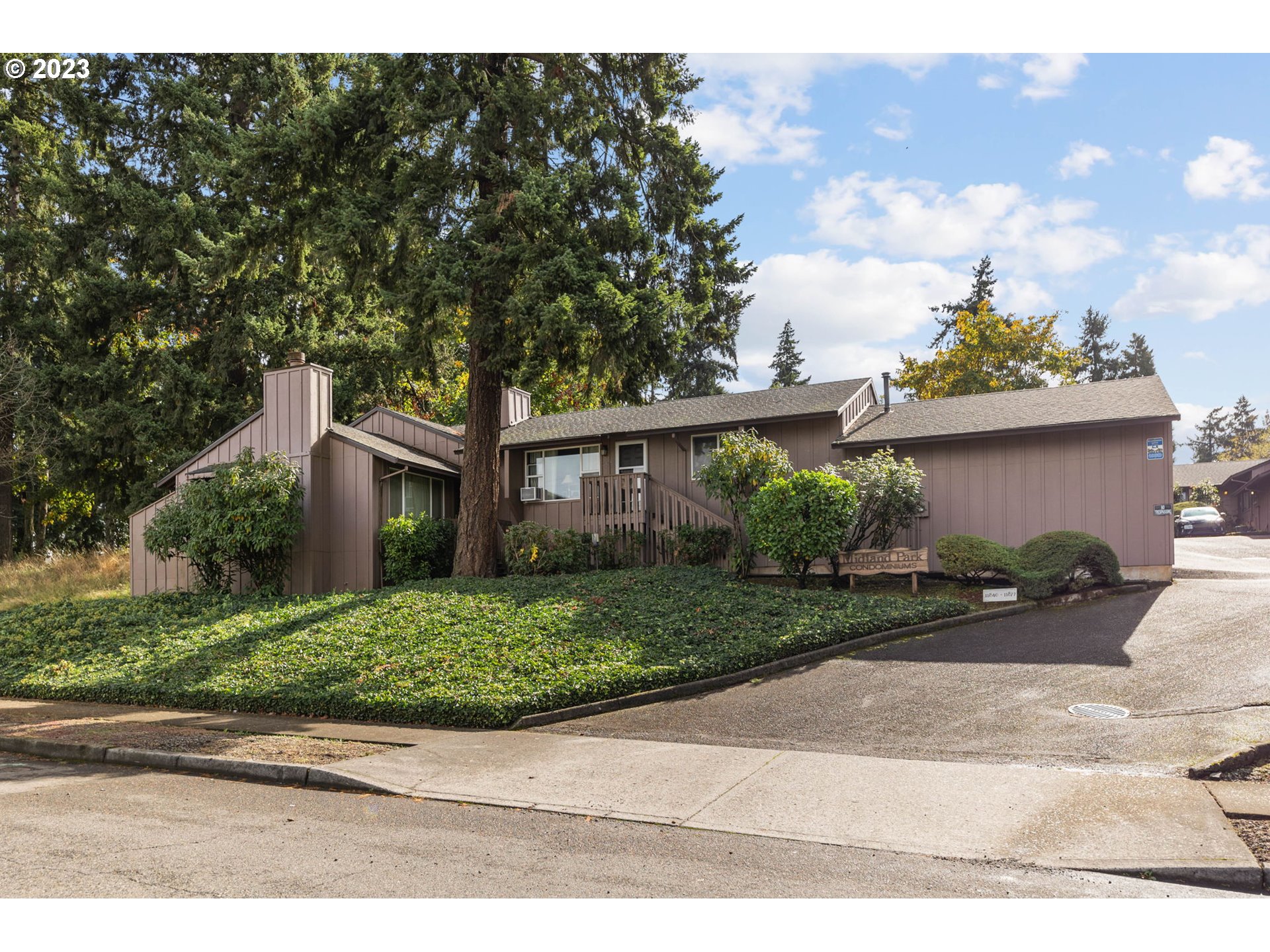 11856 Southeast Morrison Street Portland, OR 97216 - Photo 1 of 26 a front view of a house with a yard and a garage
