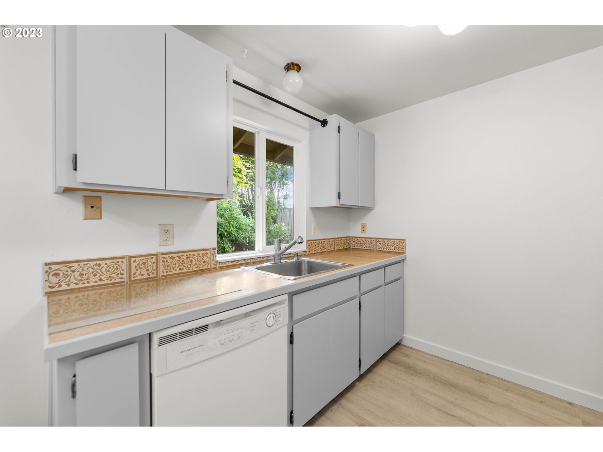 11856 Southeast Morrison Street Portland, OR 97216 - Photo 11 of 26 a kitchen with a sink cabinets and window