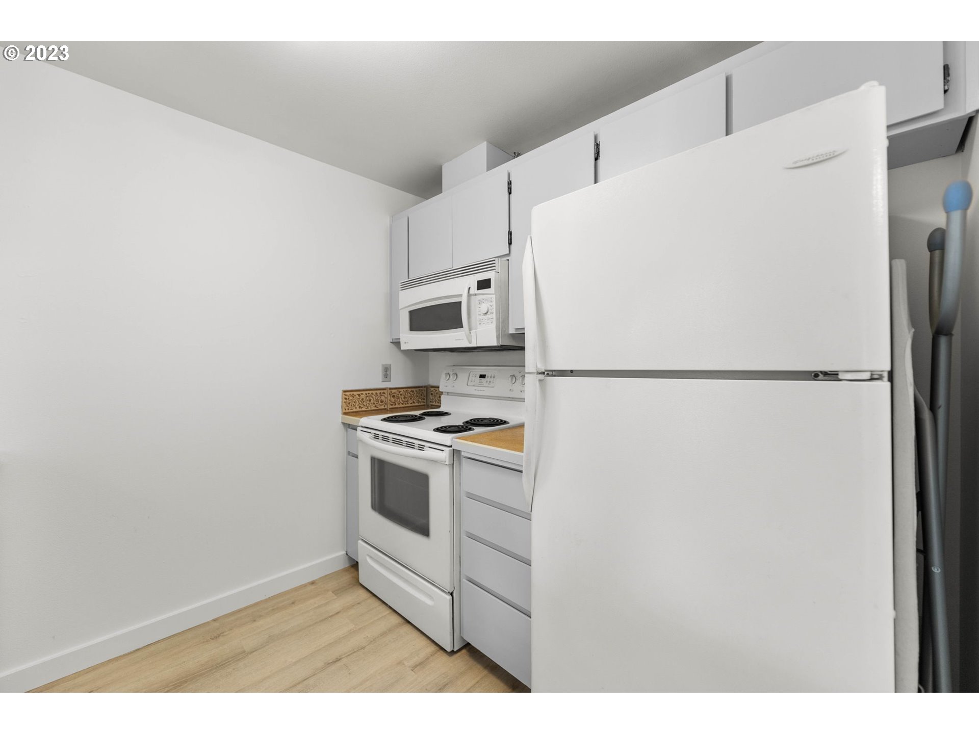11856 Southeast Morrison Street Portland, OR 97216 - Photo 12 of 26 a kitchen with cabinets and white stainless steel appliances