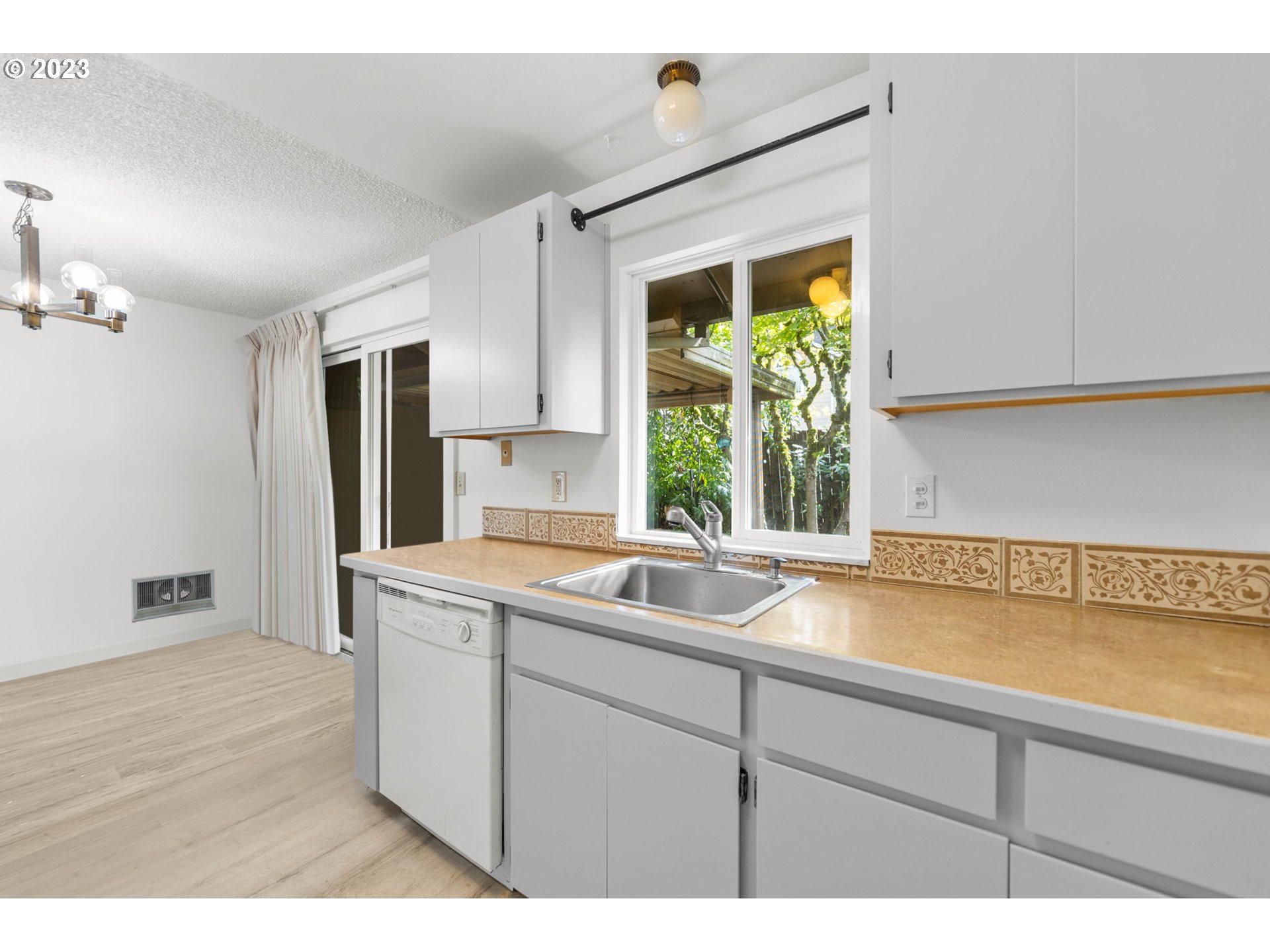 11856 Southeast Morrison Street Portland, OR 97216 - Photo 14 of 26 a kitchen with a sink and a large mirror