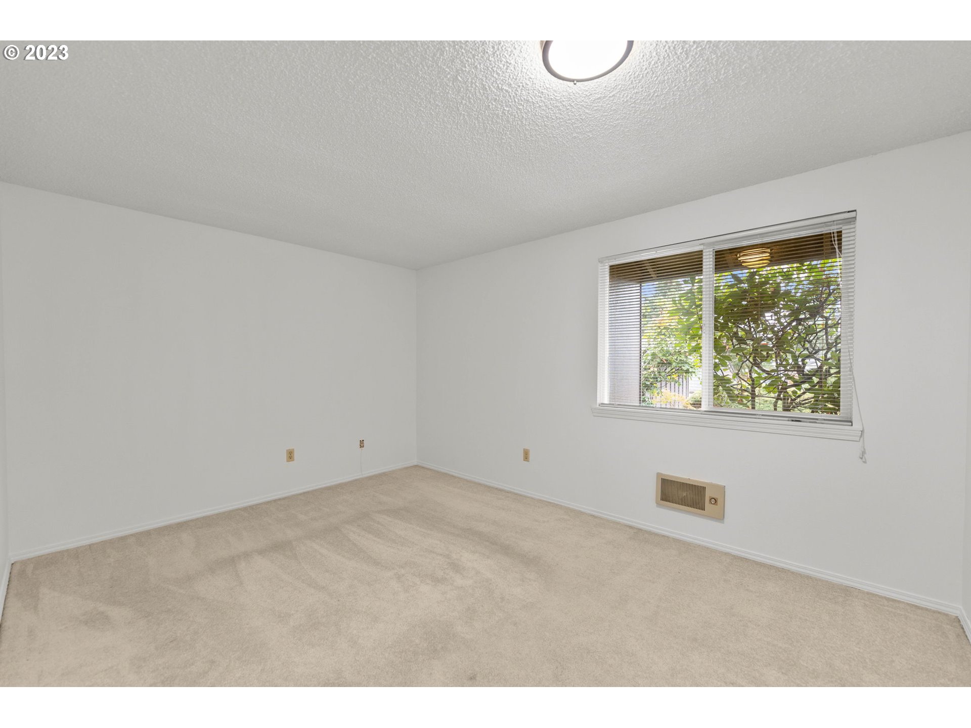 11856 Southeast Morrison Street Portland, OR 97216 - Photo 15 of 26 a view of an empty room with a window
