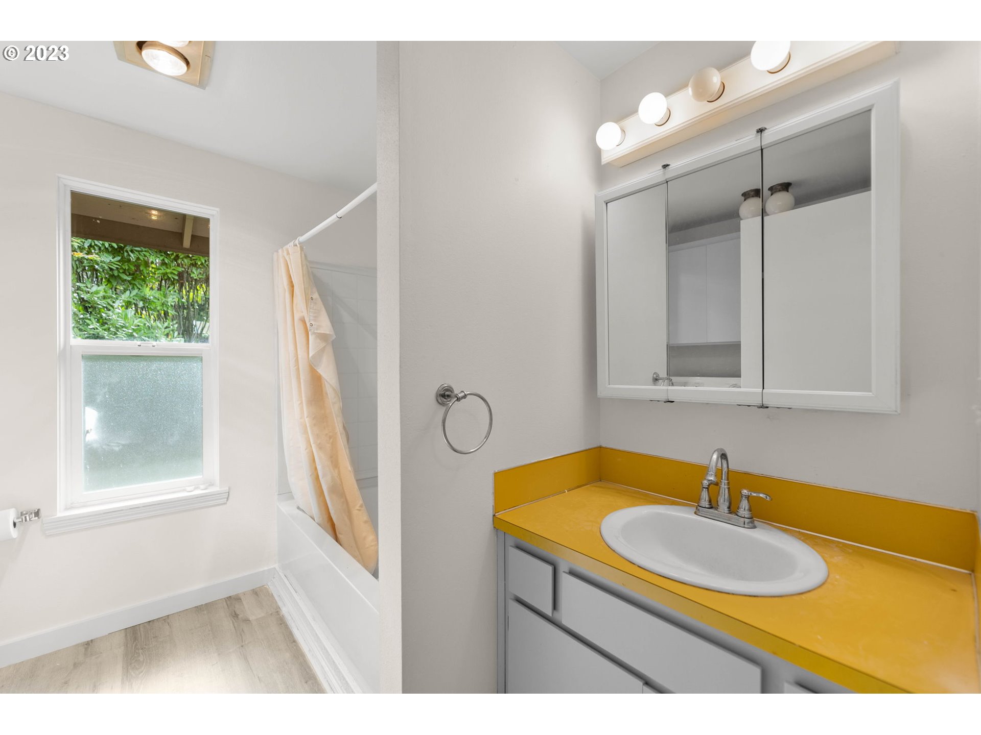 11856 Southeast Morrison Street Portland, OR 97216 - Photo 17 of 26 a bathroom with a sink a window and a mirror