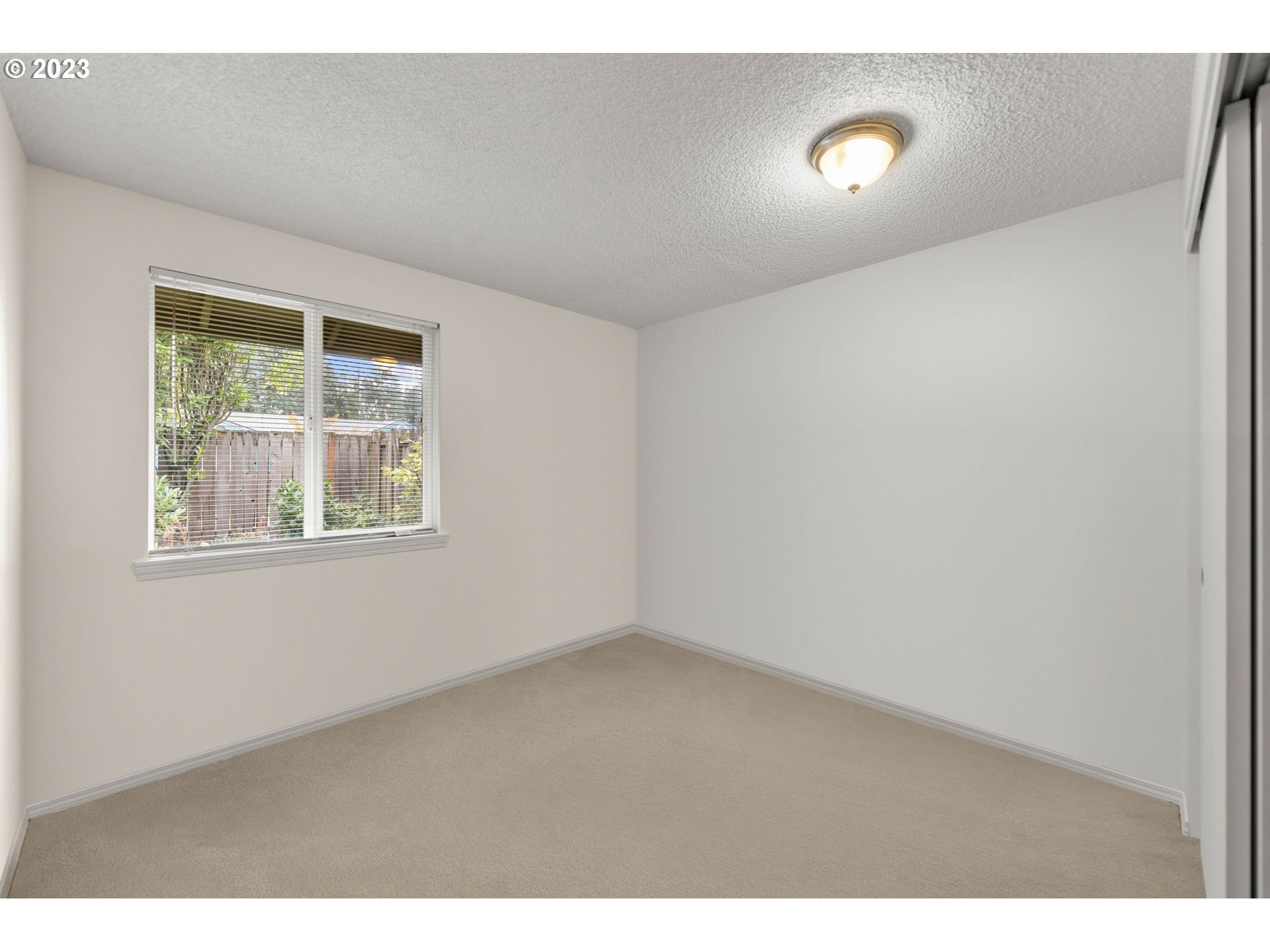 11856 Southeast Morrison Street Portland, OR 97216 - Photo 20 of 26 a view of an empty room with a window