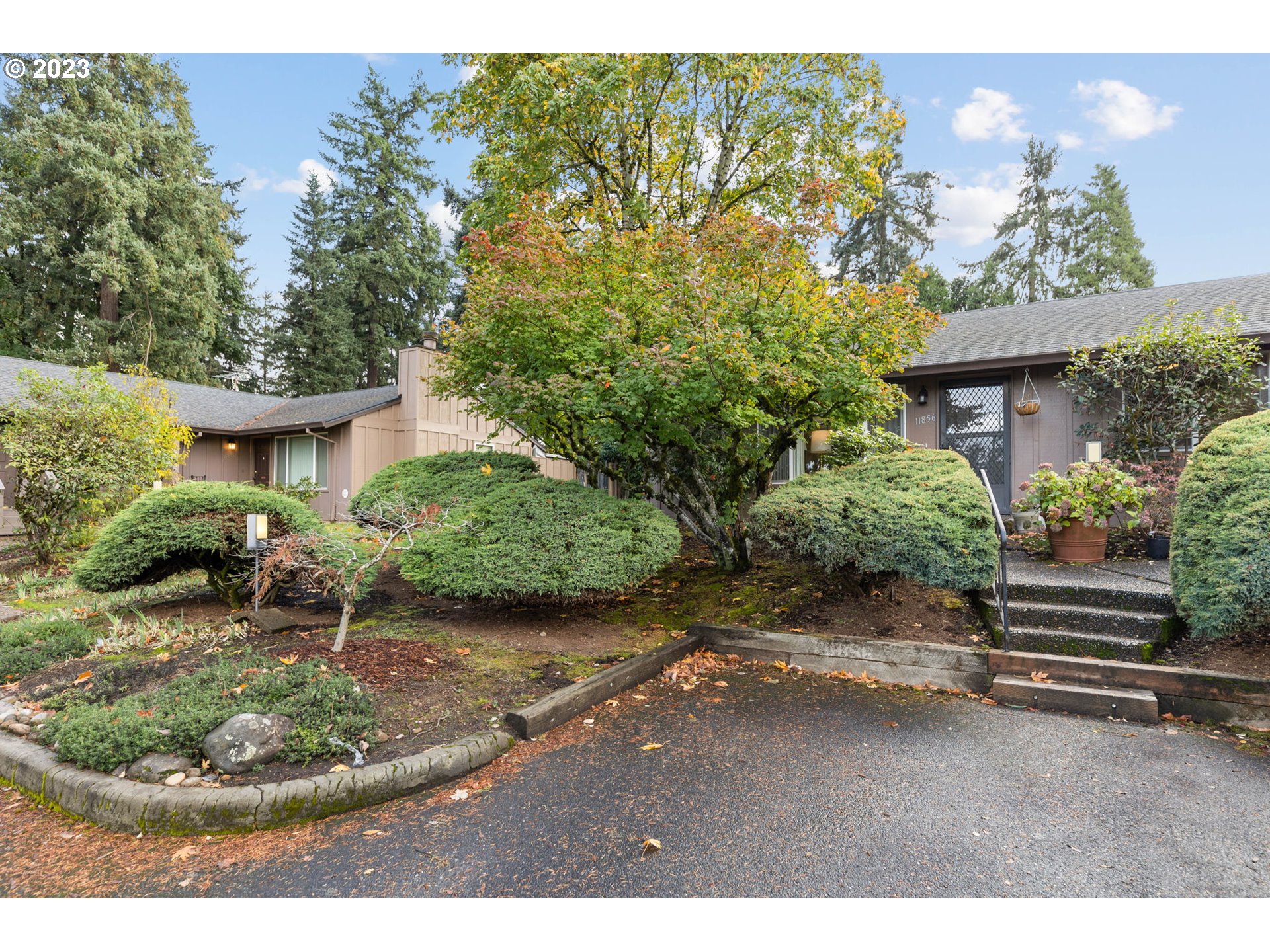 11856 Southeast Morrison Street Portland, OR 97216 - Photo 2 of 26 a view of a backyard with plants and a garden