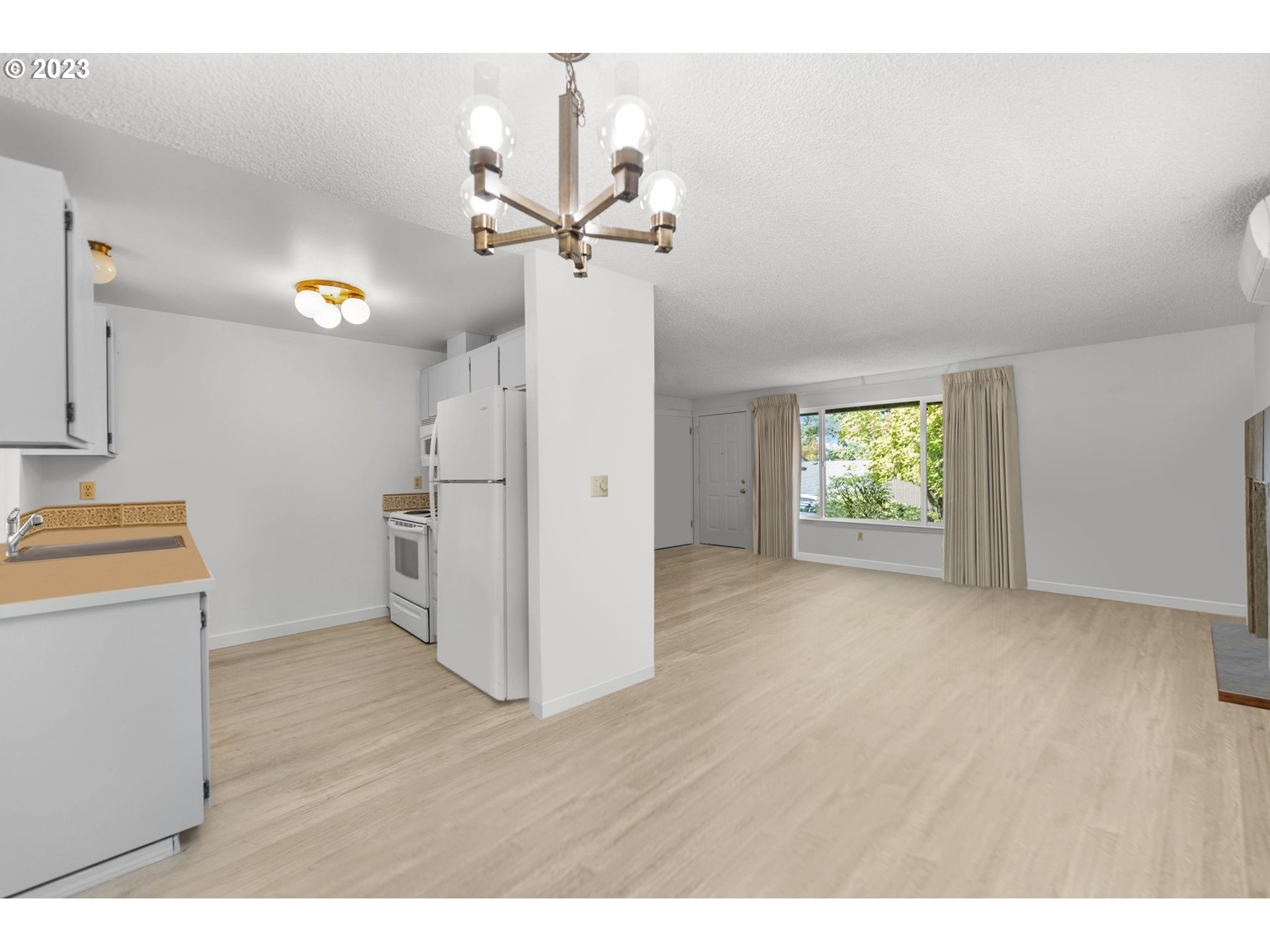 11856 Southeast Morrison Street Portland, OR 97216 - Photo 10 of 26 a view of empty room with wooden floor and window