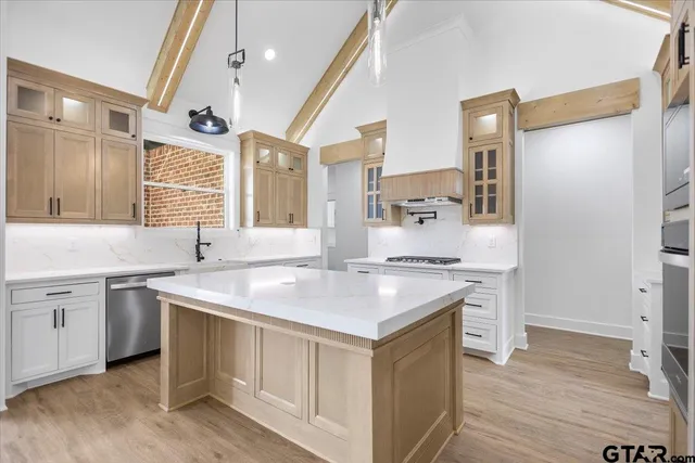 a kitchen with a sink stove and cabinets