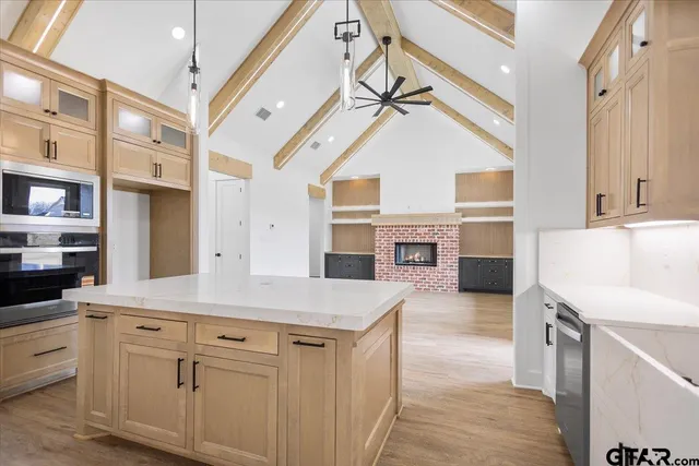 a kitchen with cabinets and wooden floor
