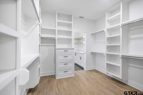 a bathroom with a bathtub shower sink mirror and toilet