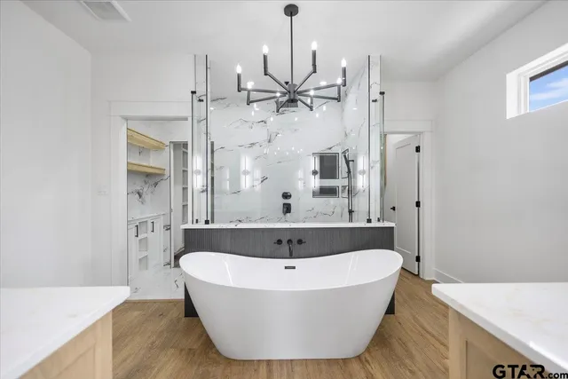 an empty room with a window and a ceiling fan