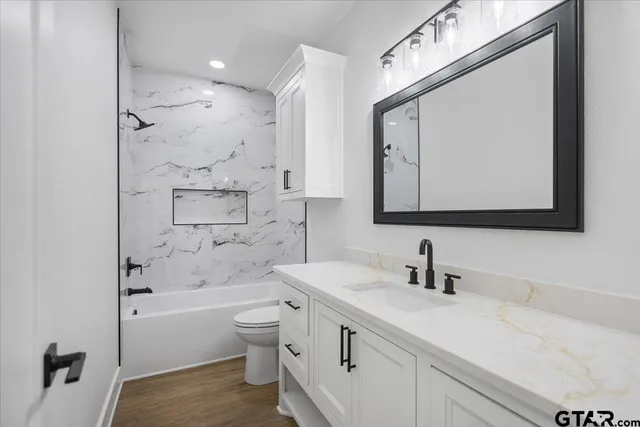 a bathroom with a double vanity sink mirror double and shower