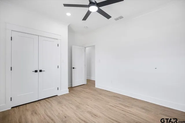 a bathroom with a toilet a sink a mirror a bathtub and vanity