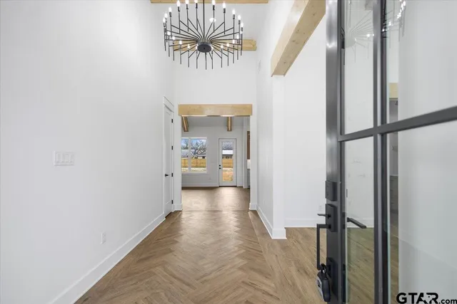 a view of a hallway and a livingroom with furniture