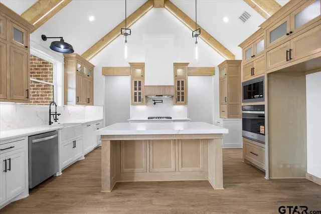 a kitchen with a sink stainless steel appliances and cabinets