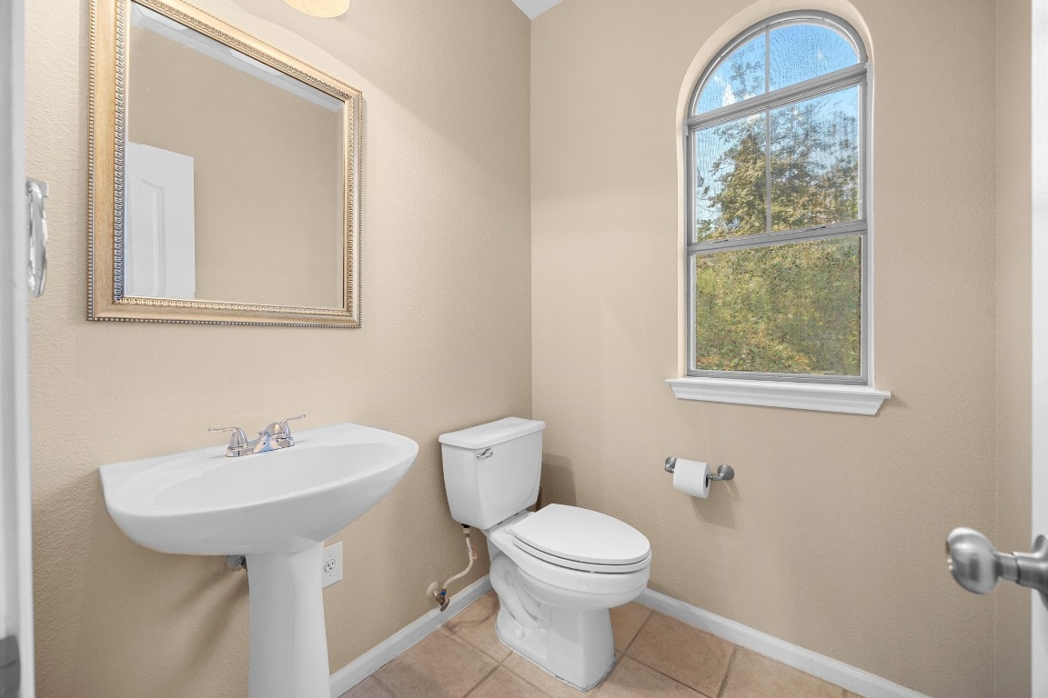 11203 Ranch Road 2222, Unit 1105 Austin, TX 78730 - Photo 12 of 35 a bathroom with a toilet a sink and a window