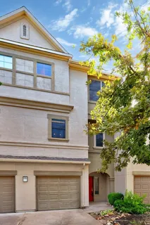 a front view of a house with plants