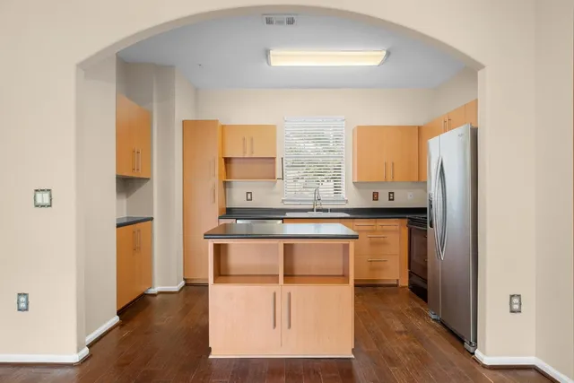a kitchen with stainless steel appliances granite countertop a stove a sink and a refrigerator