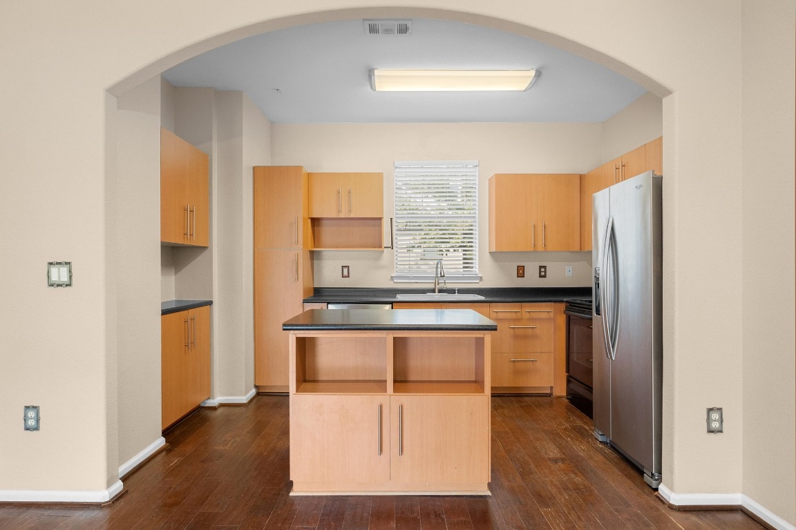 11203 Ranch Road 2222, Unit 1105 Austin, TX 78730 - Photo 9 of 35 a kitchen with stainless steel appliances granite countertop a stove a sink and a refrigerator