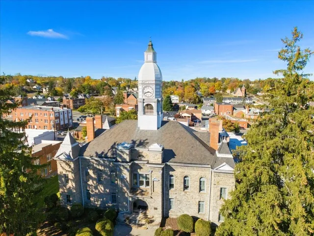 an aerial view of a city with lots of residential buildings and ocean view