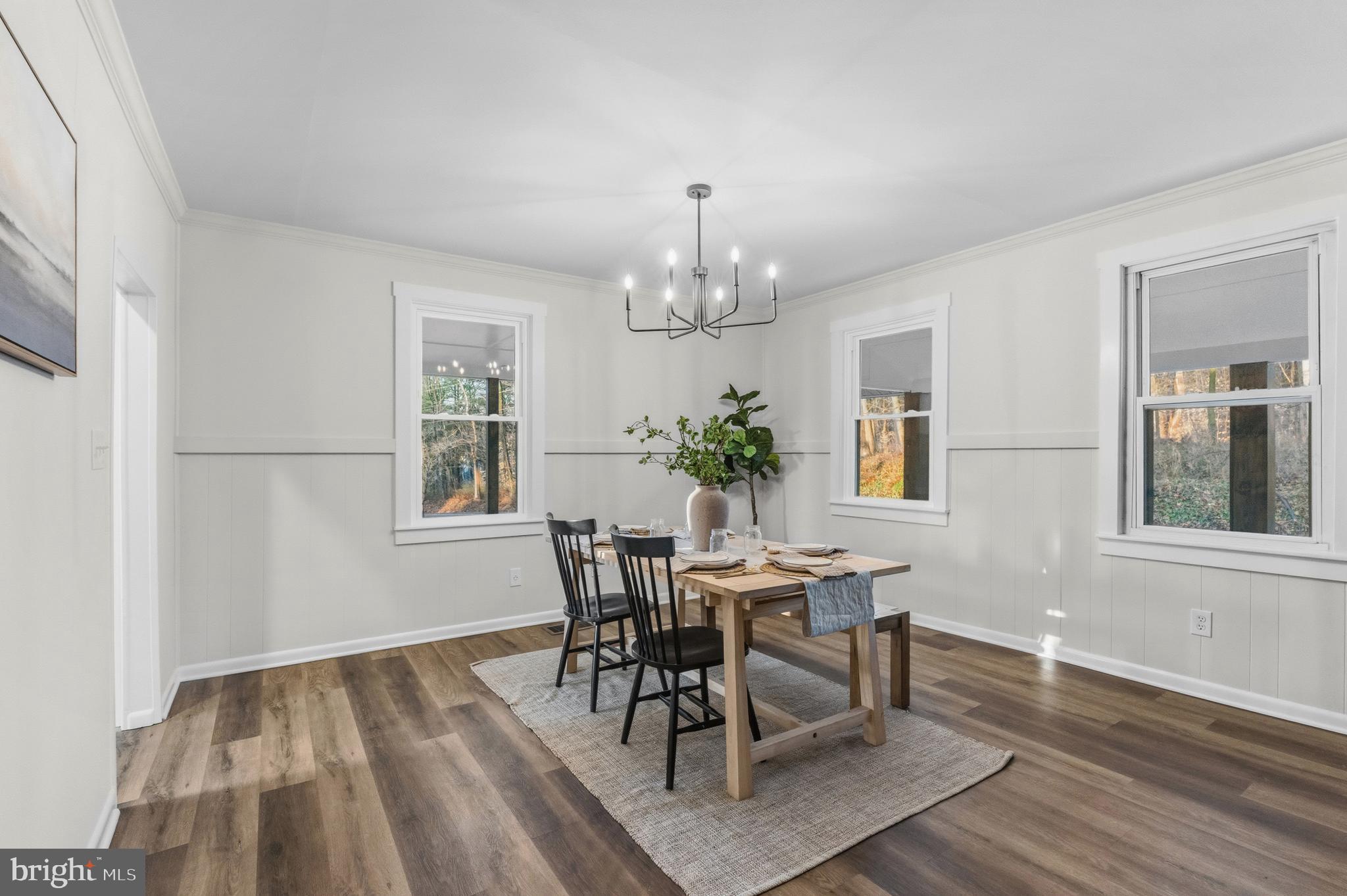 541 Robinhood Road Havre de Grace, MD 21078 - Photo 7 of 49 a dining room with wooden floor a chandelier a wooden table and chairs