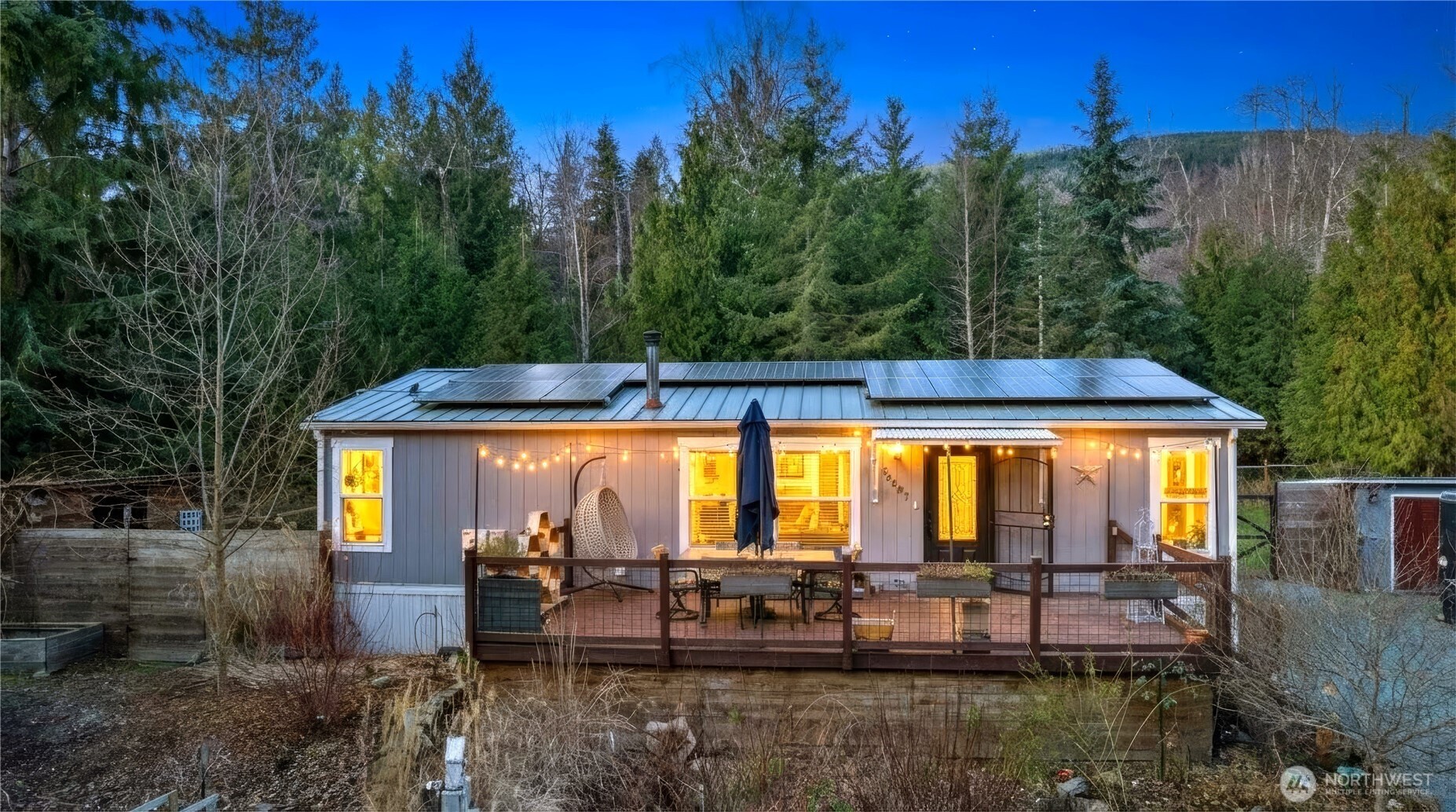 26497 Helmick Road Sedro-Woolley, WA 98284 - Photo 1 of 30 a view of a swimming pool with a table and chairs under an umbrella