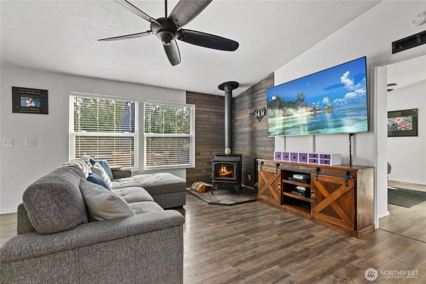 26497 Helmick Road Sedro-Woolley, WA 98284 - Photo 6 of 30 a living room with furniture a flat screen tv and a large window