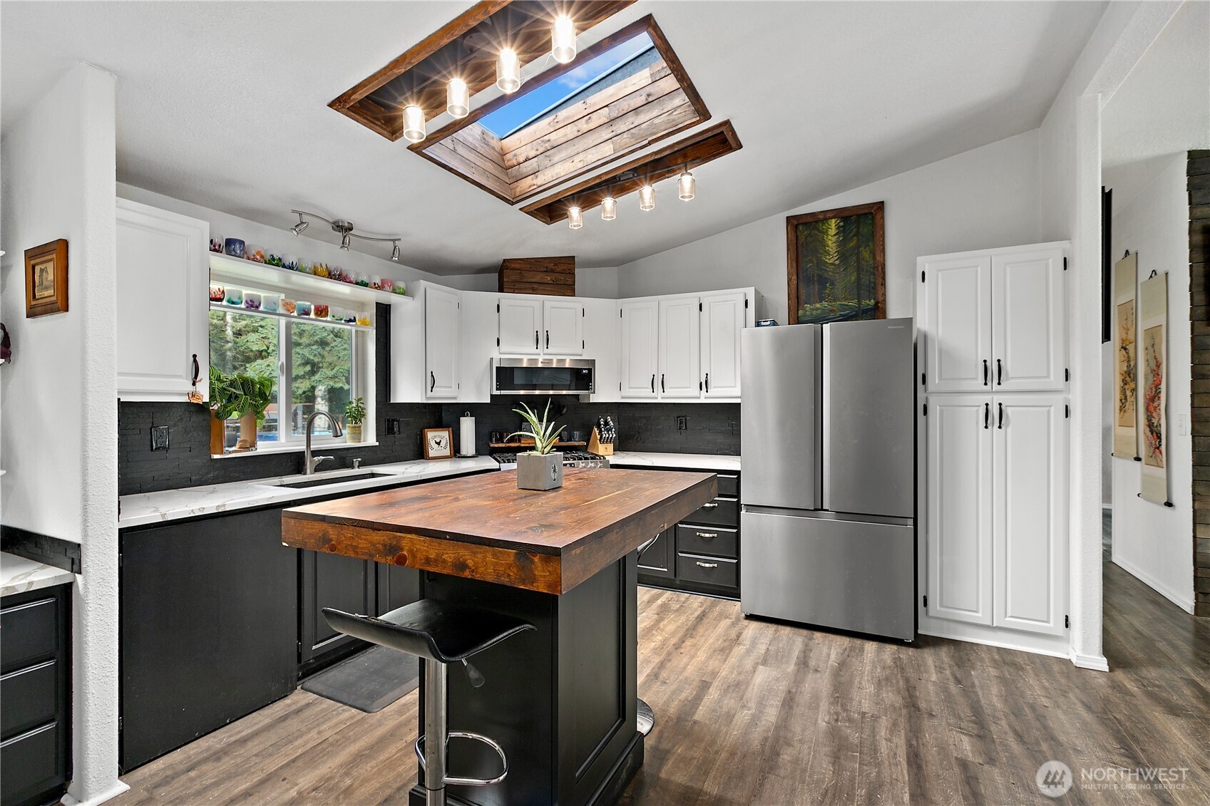 26497 Helmick Road Sedro-Woolley, WA 98284 - Photo 9 of 30 a kitchen with stainless steel appliances granite countertop a refrigerator a sink dishwasher a stove and a refrigerator with wooden floor