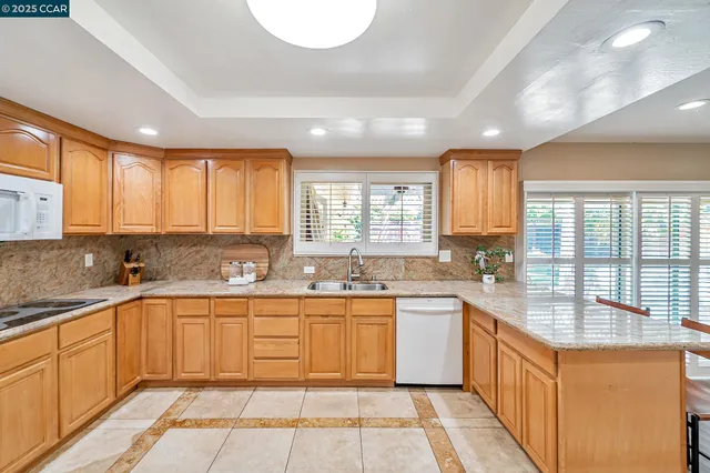 a large kitchen with a sink and cabinets