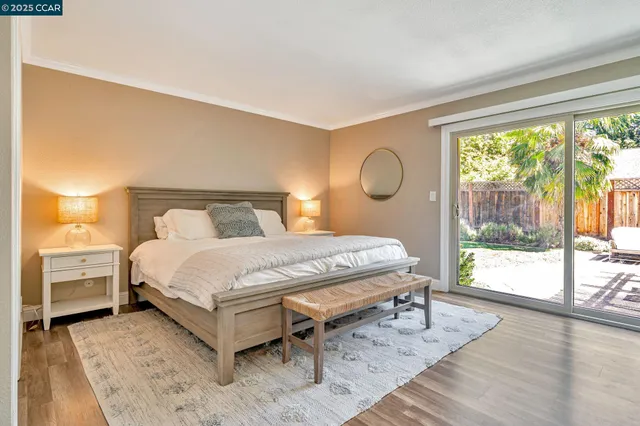 a bedroom with a bed and a large window