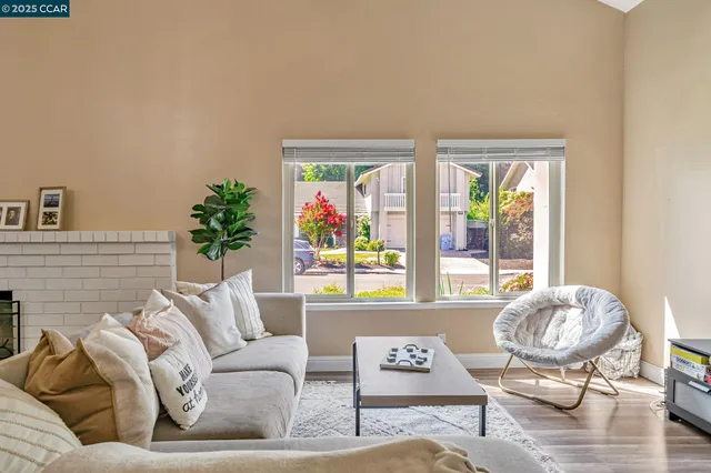 a living room with furniture and a floor to ceiling window