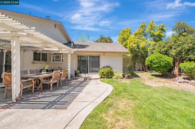 a view of a house with backyard porch and sitting area