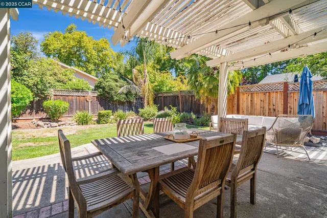 a view of a table and chairs in patio of the house
