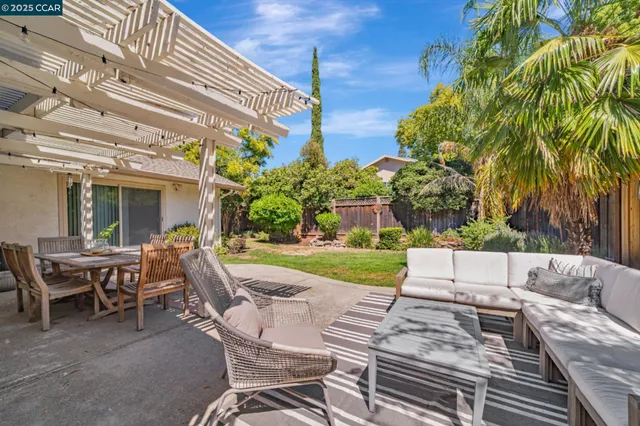 a view of a house with backyard and sitting area