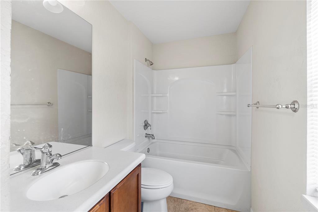 4199 Southwest 46th Court Ocala, FL 34474 - Photo 23 of 50 a bathroom with a sink a toilet and shower