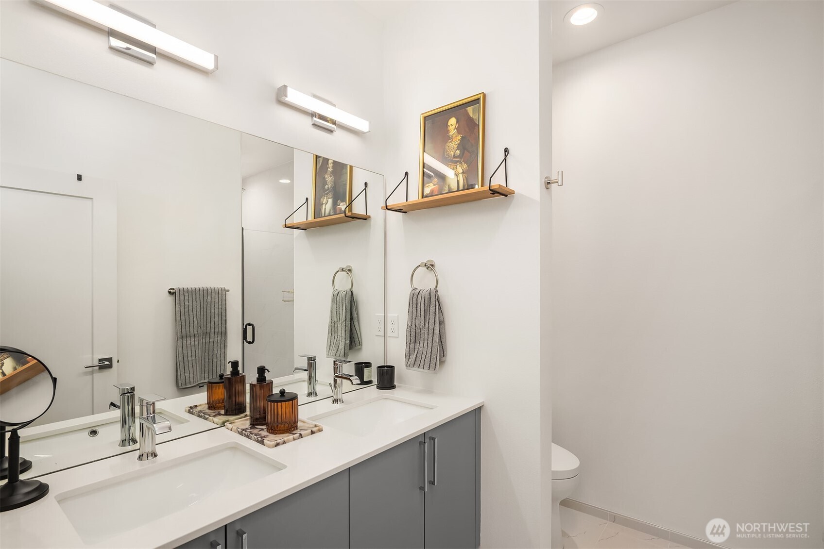 1827 14th Avenue, Unit B Seattle, WA 98122 - Photo 15 of 27 a bathroom with a double vanity sink and a mirror