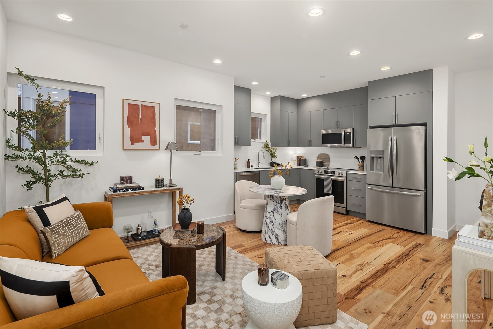 1827 14th Avenue, Unit B Seattle, WA 98122 - Photo 17 of 27 a living room with furniture a refrigerator and kitchen view
