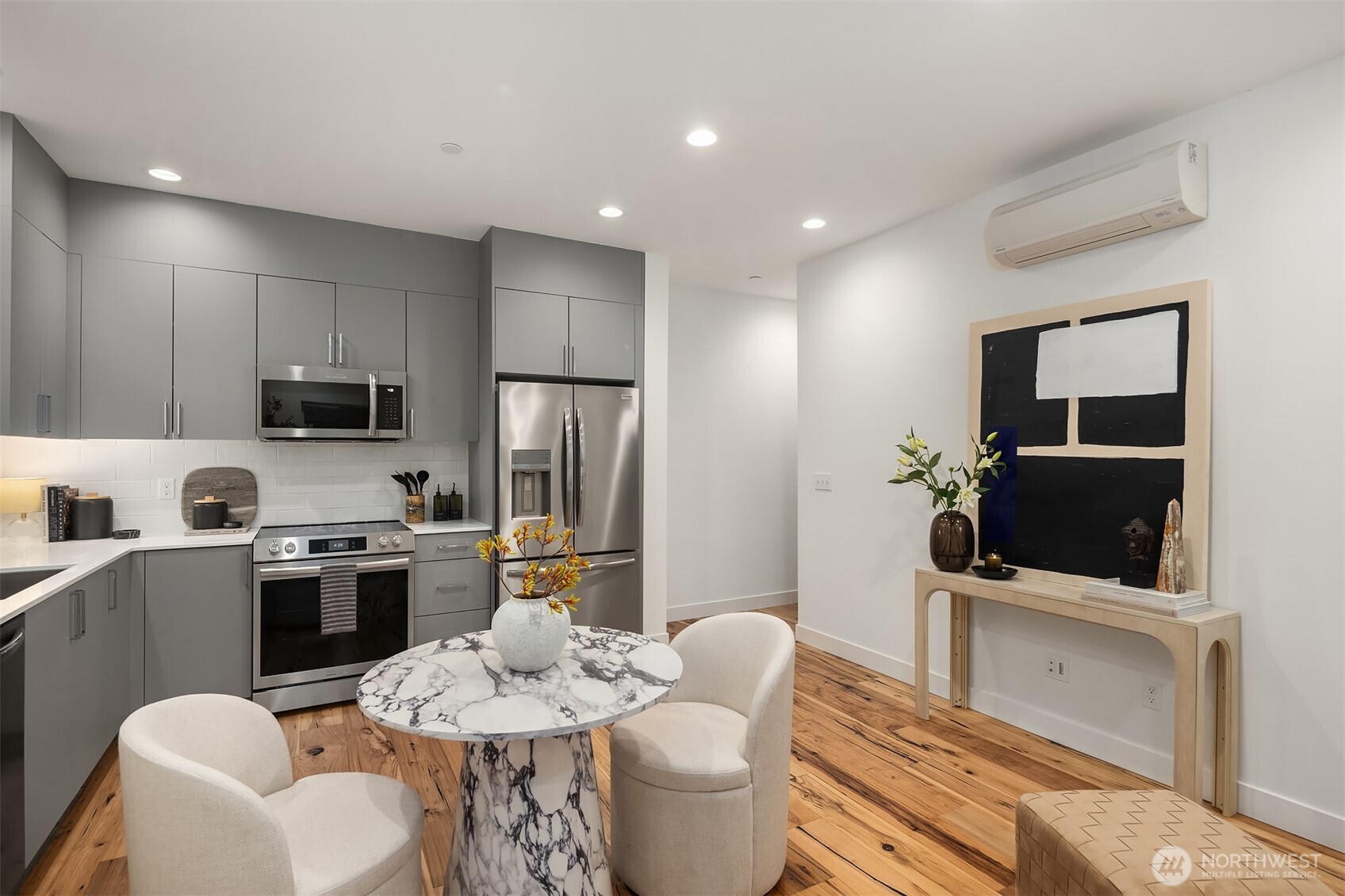 1827 14th Avenue, Unit B Seattle, WA 98122 - Photo 18 of 27 a kitchen with stainless steel appliances a stove a sink a microwave a refrigerator and cabinets
