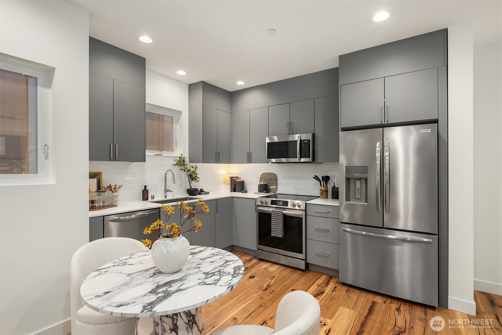 1827 14th Avenue, Unit B Seattle, WA 98122 - Photo 21 of 27 a kitchen with cabinets stainless steel appliances and wooden floor
