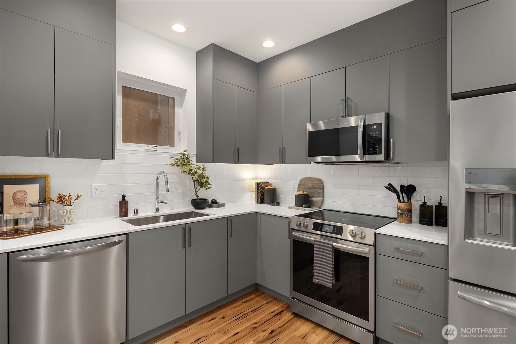1827 14th Avenue, Unit B Seattle, WA 98122 - Photo 5 of 27 a kitchen with a sink and steel appliances
