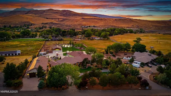 an aerial view of a house with garden space and mountain view