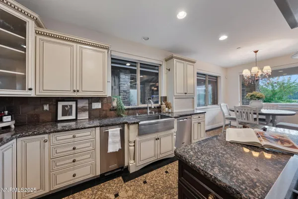 a bathroom with a granite countertop sink a mirror and shower