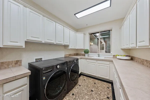 a view of a patio with couches table and chairs with wooden floor