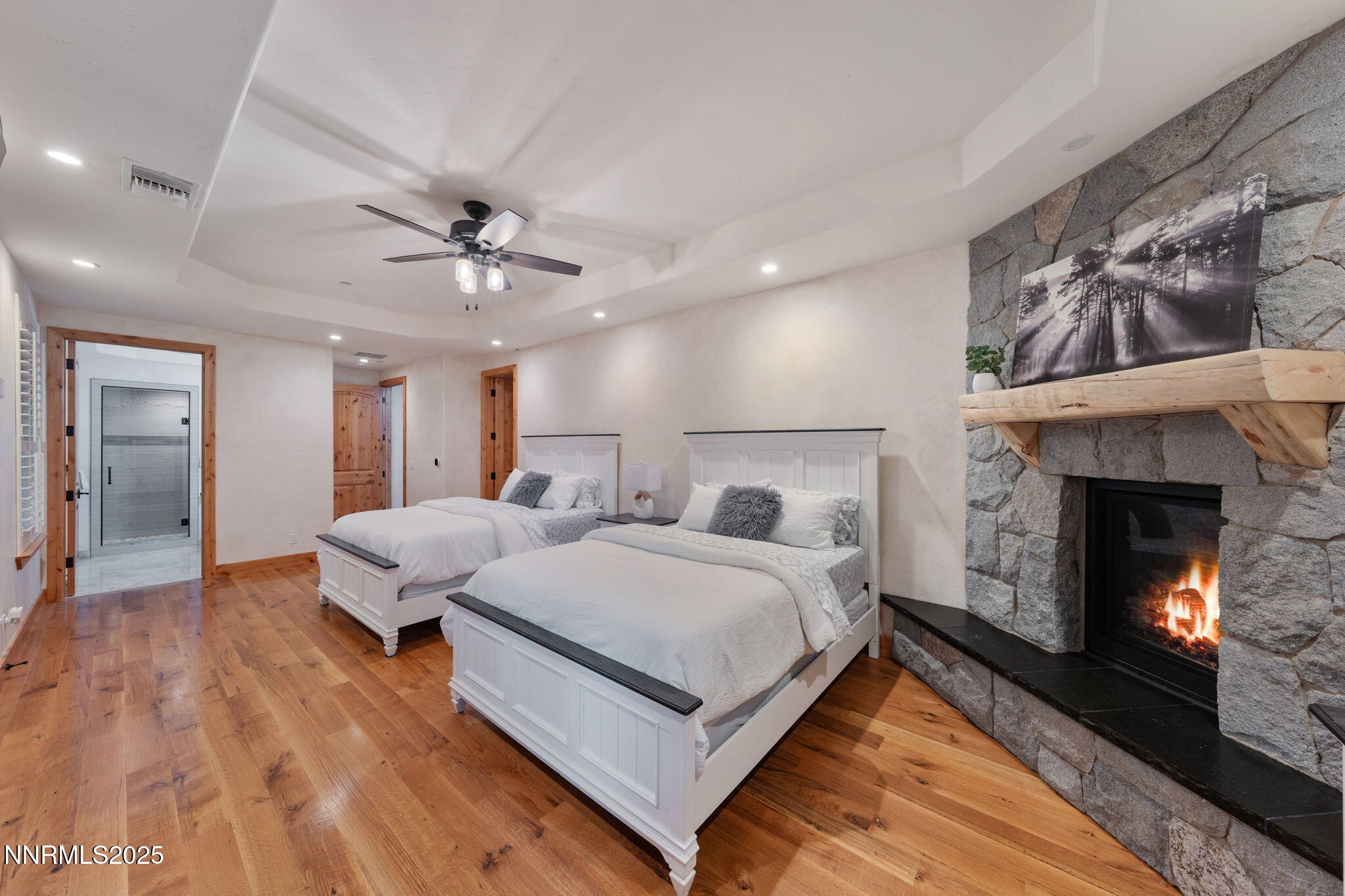 95 Ox-Yoke Lane Reno, NV 89521 - Photo 74 of 160 a spacious bedroom with a bed and a fireplace