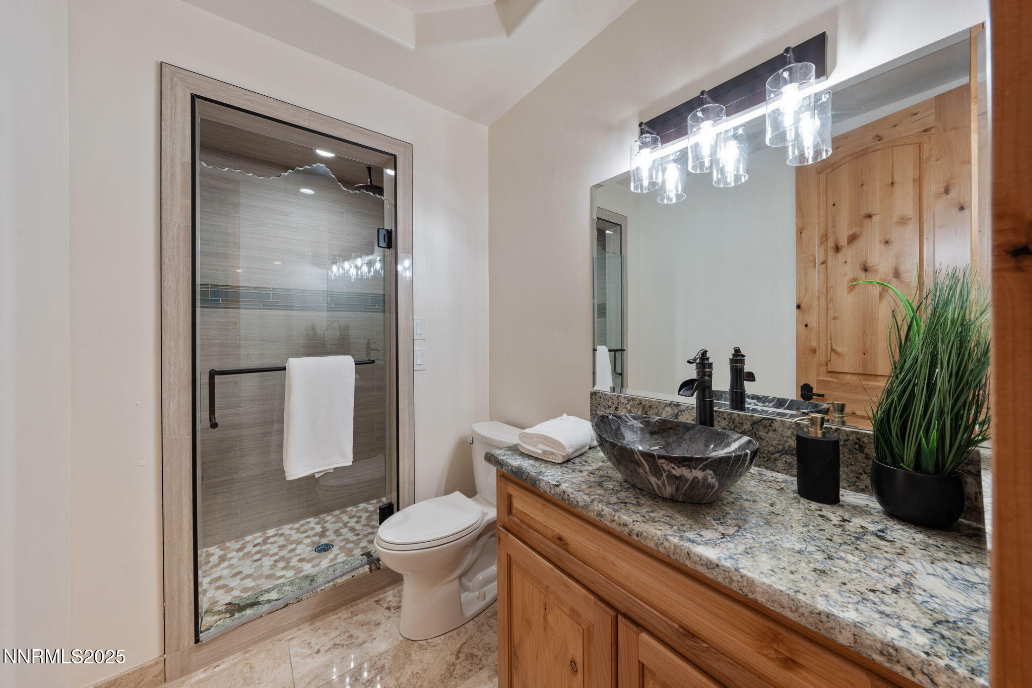 95 Ox-Yoke Lane Reno, NV 89521 - Photo 82 of 160 a bathroom with a granite countertop sink a toilet a mirror and shower
