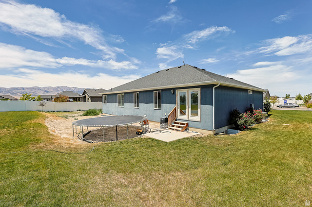 712 East Sunset View Road Grantsville, UT 84029 - Photo 5 of 44 Rear exterior, french doors leading out to an expansive backyard.