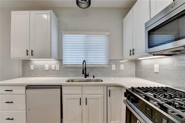 a view of a big room with wooden floor ceiling fan and windows