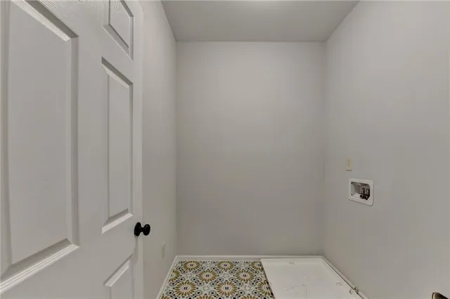 a view of a room with wooden floor and a ceiling fan