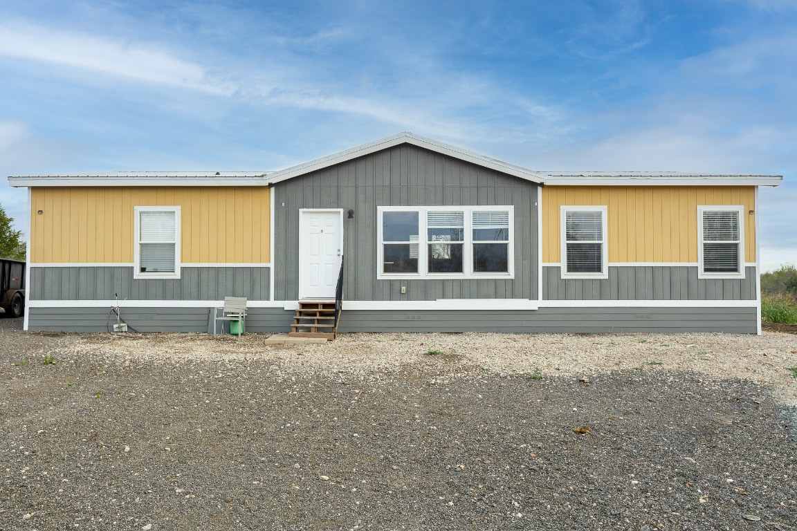 a view of a house with a large window and an empty room